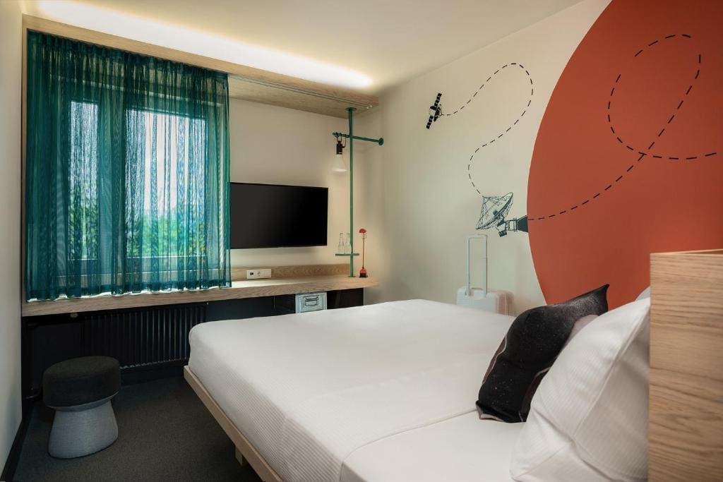 Bright hotel room with bed and desk
